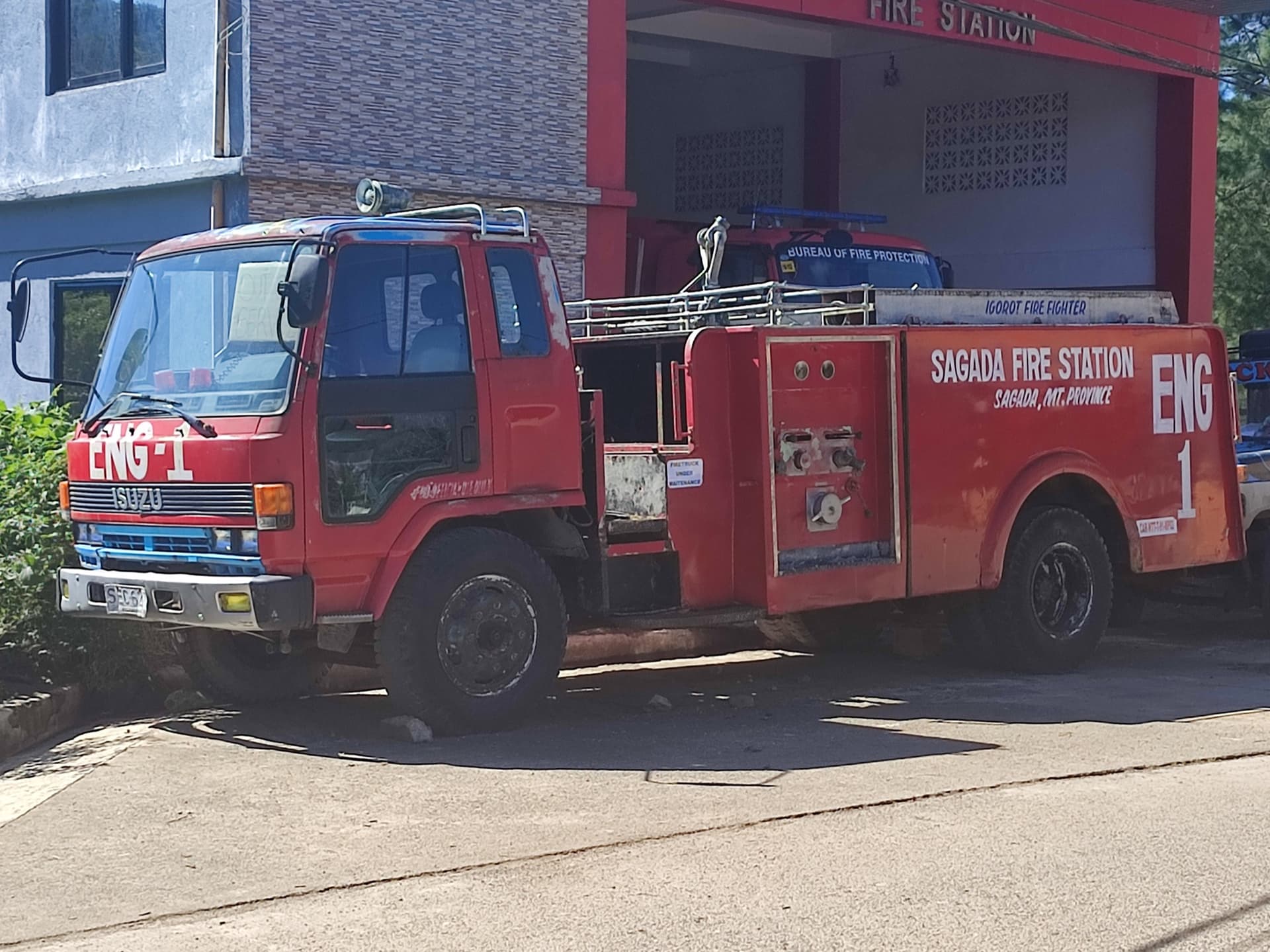 A third generation Isuzu Forward L195 used as a fire truck by the municipality of Sagada , Mountain Province , photographed along Staunton Road, Sagada, Mountain Province, Philippines.
